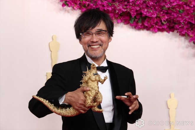 Director Takashi Yamazaki walking the red carpet with the golden Godzilla.