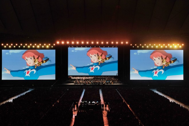 Joe Hisaishi conducts the Royal Philharmonic Orchestra at the Studio Ghibli Film Concert in Tokyo Dome.