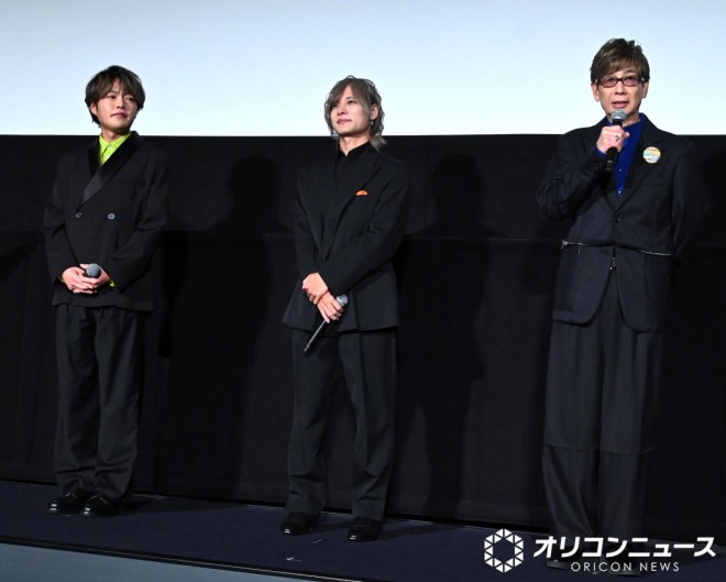 Cast and staff appear on stage 