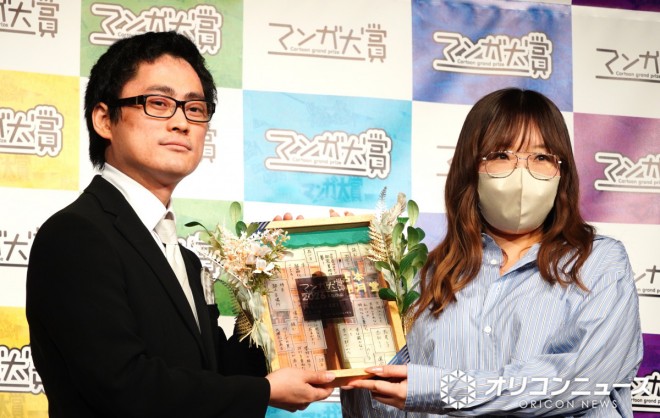 Kohei Asai, editor in charge, and Kiko Urino, author of the previous grand prize winner Alice Even to Space, pictured at the Manga Taisho 2026 award ceremony